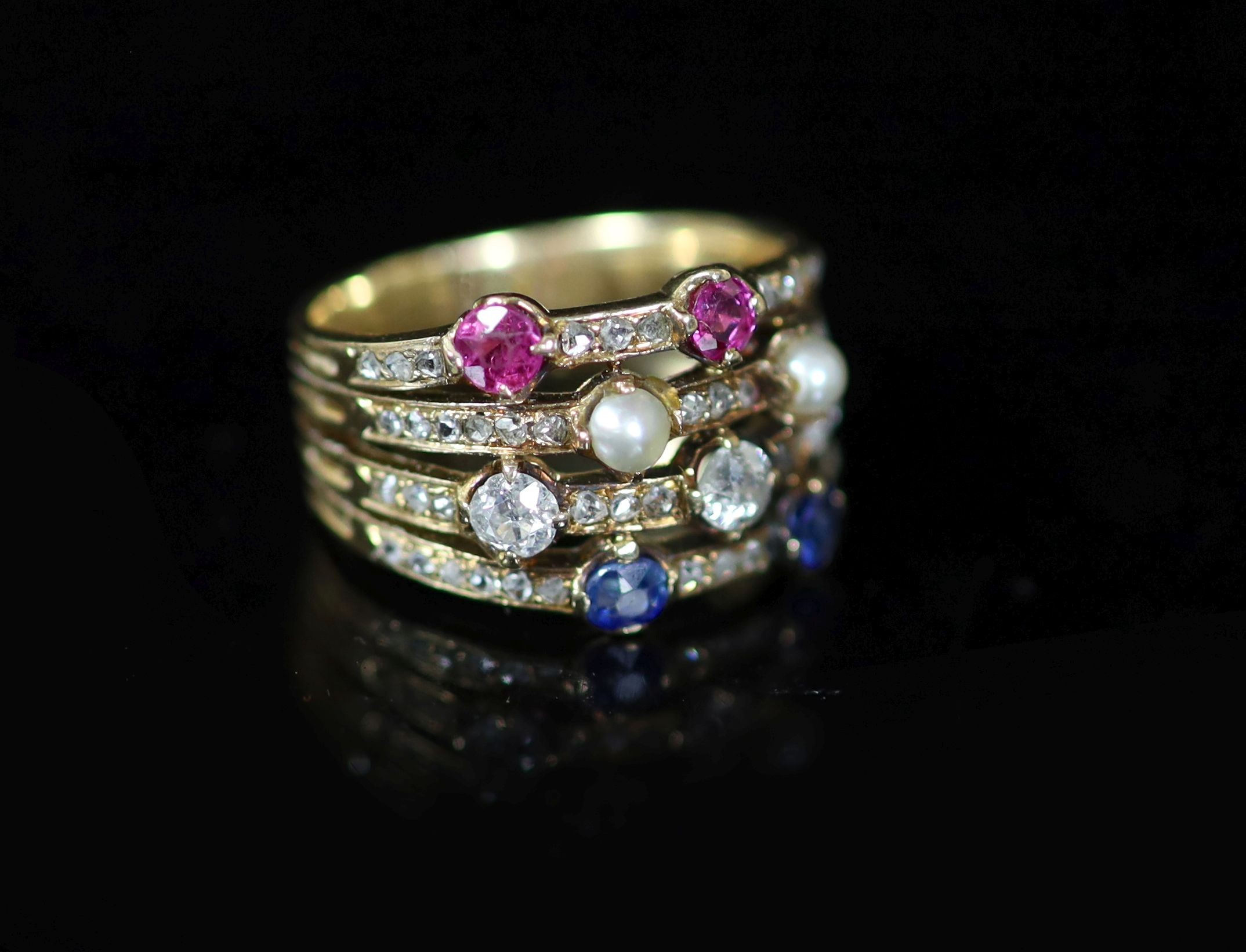 A mid 20th century gold, ruby, diamond sapphire and seed pearl set quadruple shank dress ring